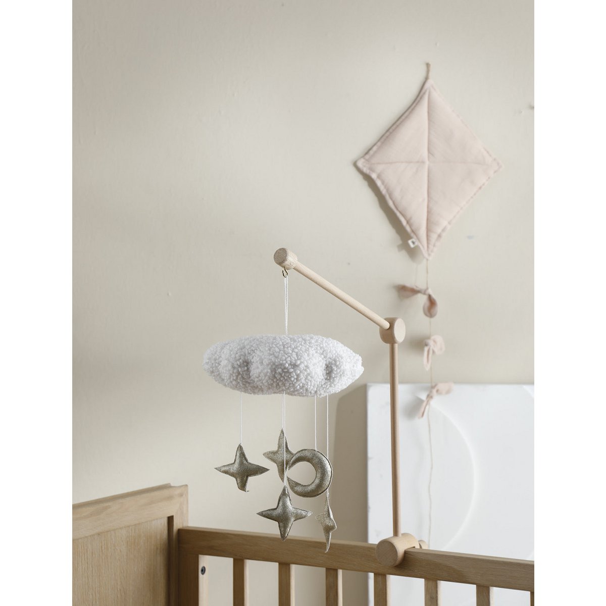 Handgefertigtes CIRRUS Mobile von 2 Stories aus Polyester in Gold, Bronze und Weiß – eine schlichte weiße Wolke schwebt über mehreren glitzernden Sternen. Das Mobile  sorgt über dem Babybett für eine traumhafte Atmosphäre.