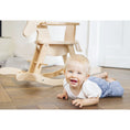 Bild in Galerie-Betrachter laden, Kind liegt vor dem Schaukelpferd 'Pinolino' aus Holz mit Sicherheitsring, naturfarben, ideal für kleine Kinder ab 1 Jahr.
